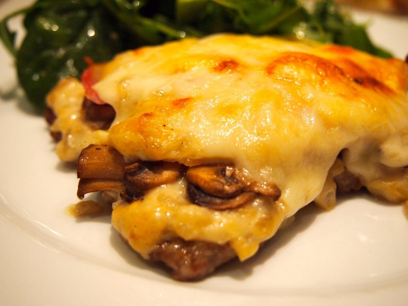 Finely Sliced Veal with Mushrooms and Cheese in the Oven