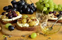 Bruschetta with Greek traditional anthotyro cheese, grape, molasses and walnuts