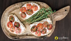 Bruschetta with tomatoes,thyme and xino-myzithra  traditional unpasteurised Greek cheese
